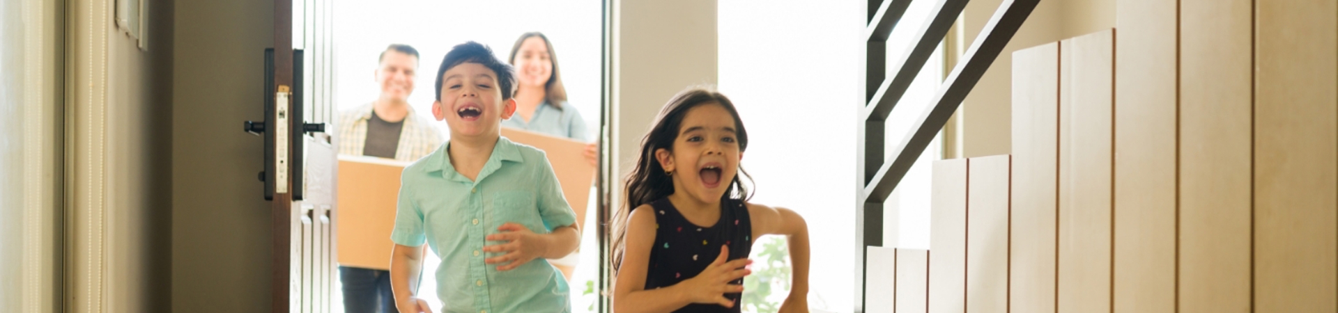 Children running into a new home