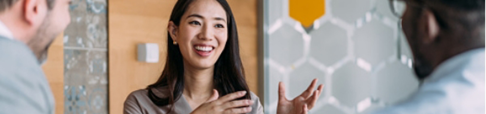 Woman sitting at a table in a group conversation