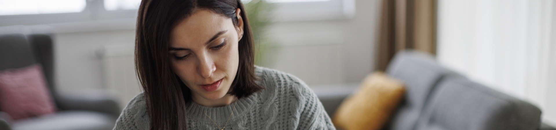 Woman sitting at a desk, doing calculations