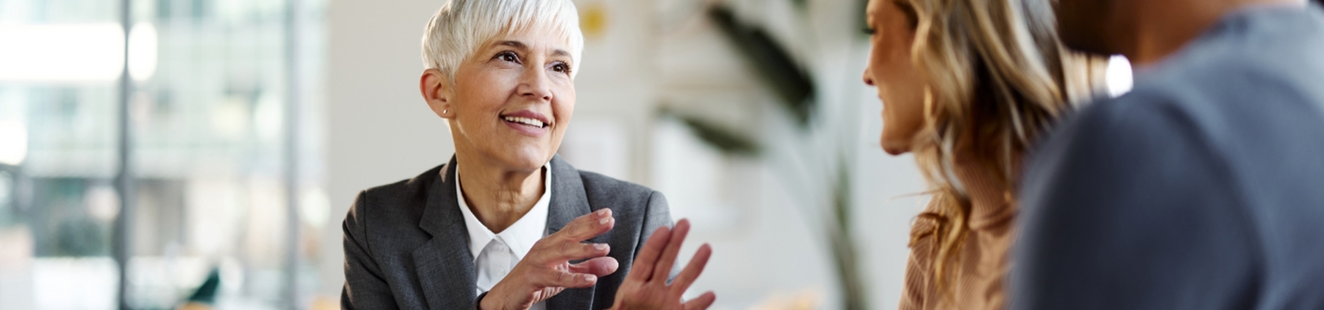 Advisor sitting a table in discussion with a couple